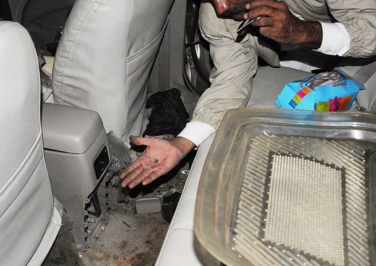 a bomb disposal official collects ball bearings from the car that was targeted with a magnetic bomb near nipa in karachi photo mohammad saqib express a bomb disposal official collects ball bearings from the car that was targeted with a magnetic bomb near nipa in karachi photo mohammad saqib express