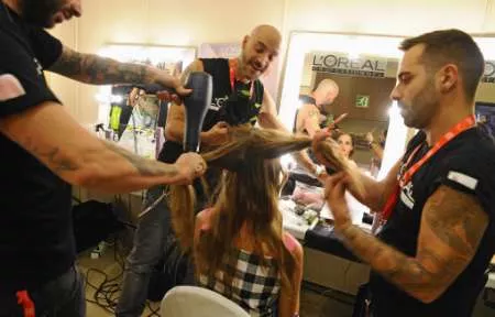a model gets her hair done backstage photo reuters a model gets her hair done backstage photo reuters