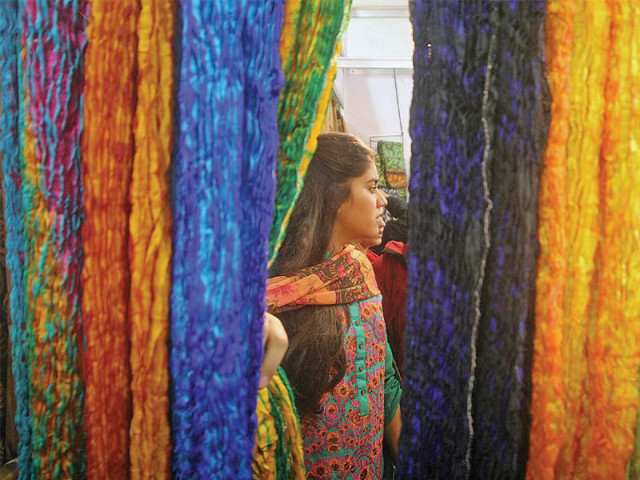 indian traders exhibit brightly coloured fabrics that have been weaved using traditional methods photo athar khan express indian traders exhibit brightly coloured fabrics that have been weaved using traditional methods photo athar khan express