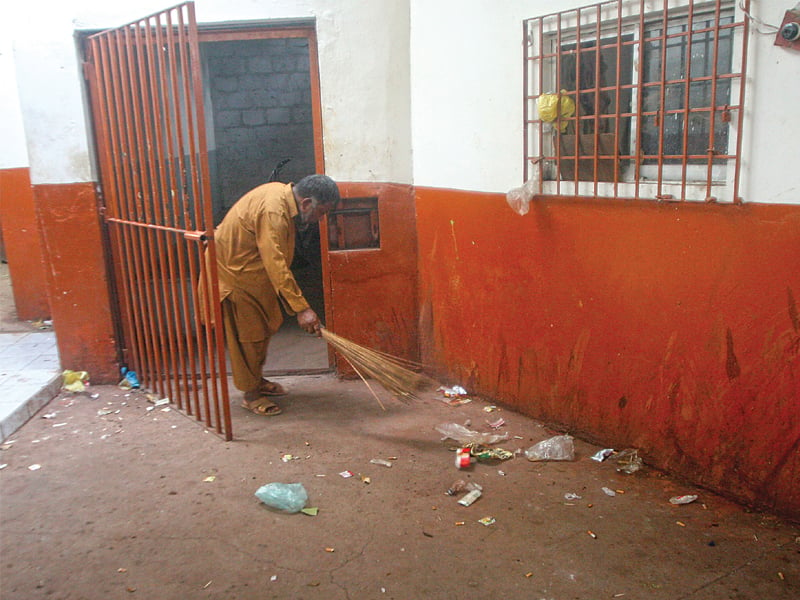 a daily wage sweeper cleans up garbage at a judicial lock up photos athar khan express