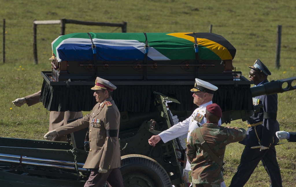 the coffin of south african former president nelson mandela is escorted as it arrives for the funeral ceremony in qunu on december 15 2013 photo afp