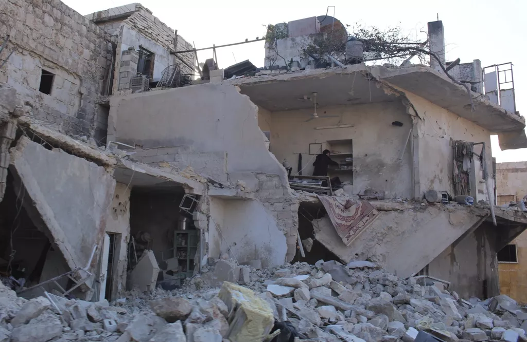 a woman inspects her damaged home in aleppo december 15 2013 photo reuters a woman inspects her damaged home in aleppo december 15 2013 photo reuters