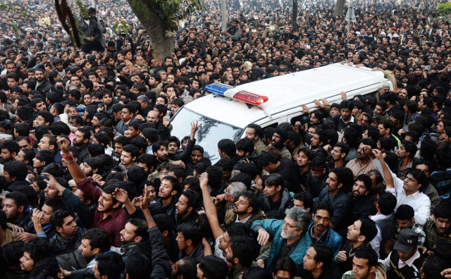 mourners surround an ambulance carrying the body of shia scholar allama nasir abbas in lahore on december 16 2013 photo afp mourners surround an ambulance carrying the body of shia scholar allama nasir abbas in lahore on december 16 2013 photo afp