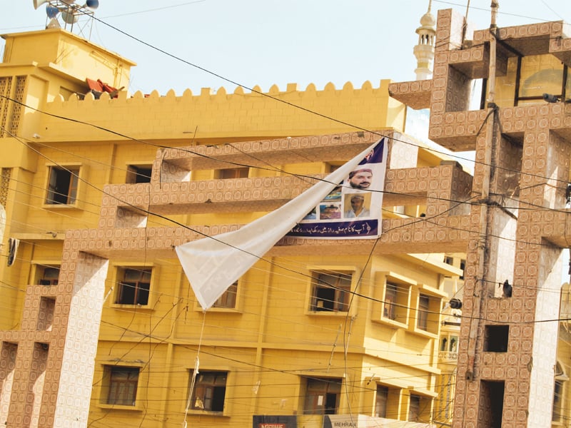 rangers put up panaflex banners of most wanted criminals in lyari on saturday but only the one above near juna masjid in kalri remained two days later photo arif soomro express