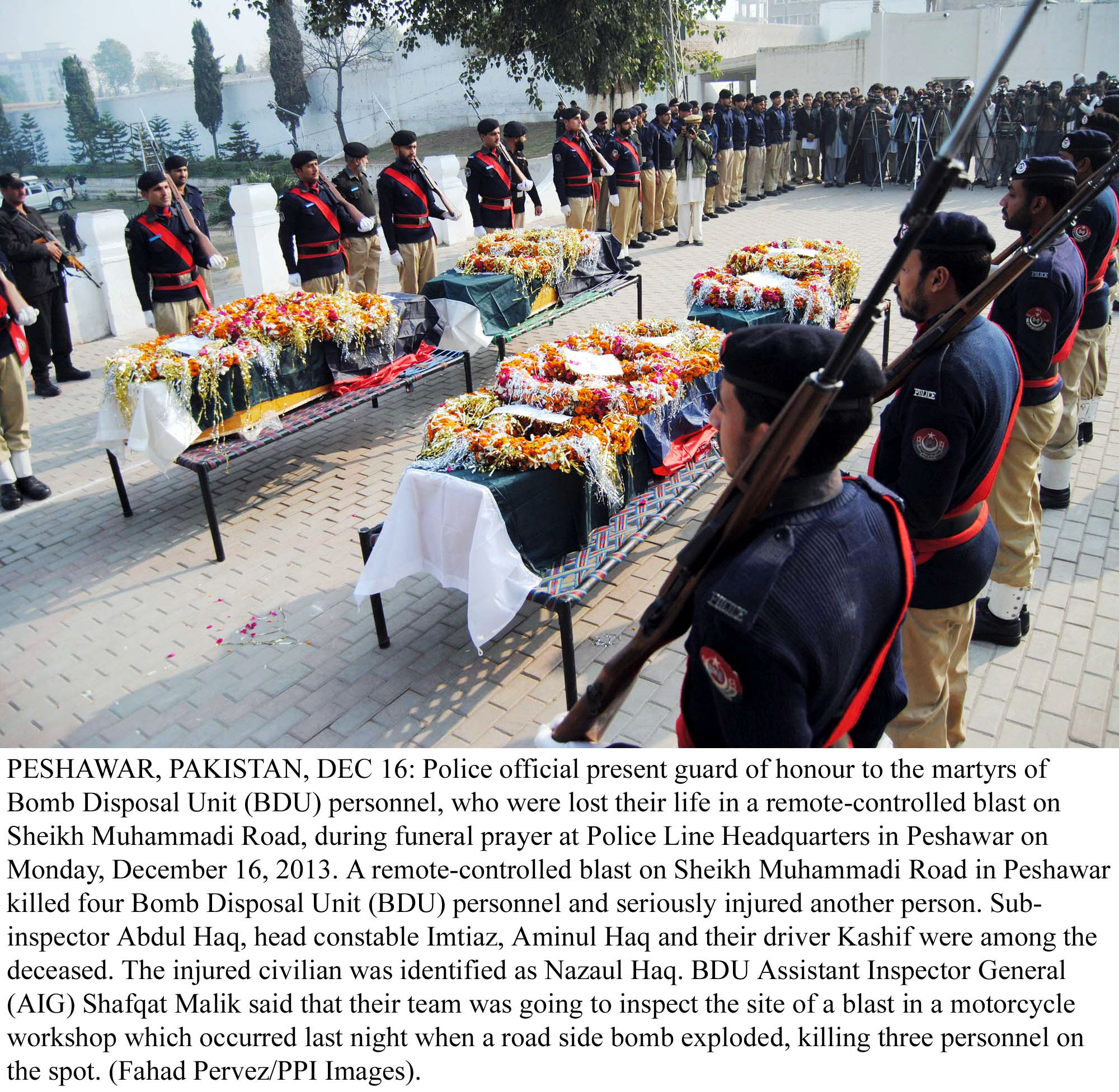 police officials present a guard of honour at the police line headquarters in peshawar on monday to the bds officials who were killed in an ied attack photo ppi