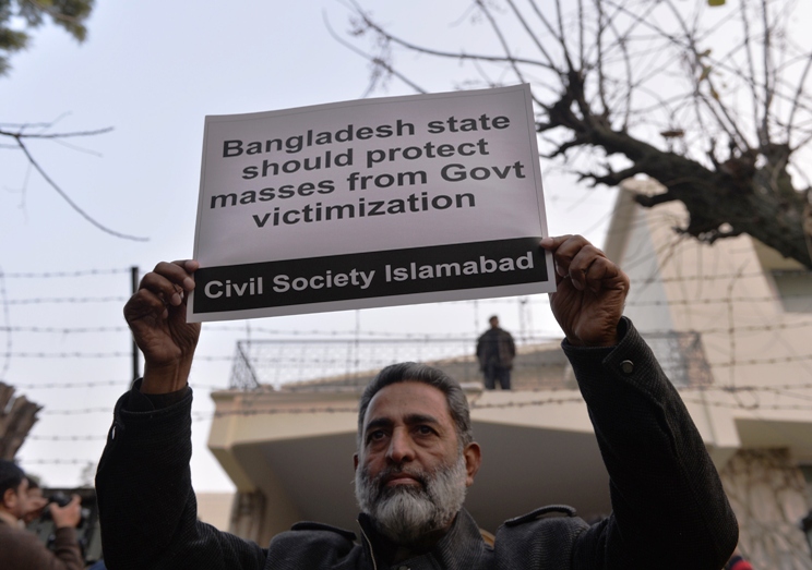 a pakistani civil society activist holds up a placard during a protest against the execution of bangladeshi islamist leader abdul quader molla outside the high commission of bangladesh in islamabad on december 17 2013 photo afp