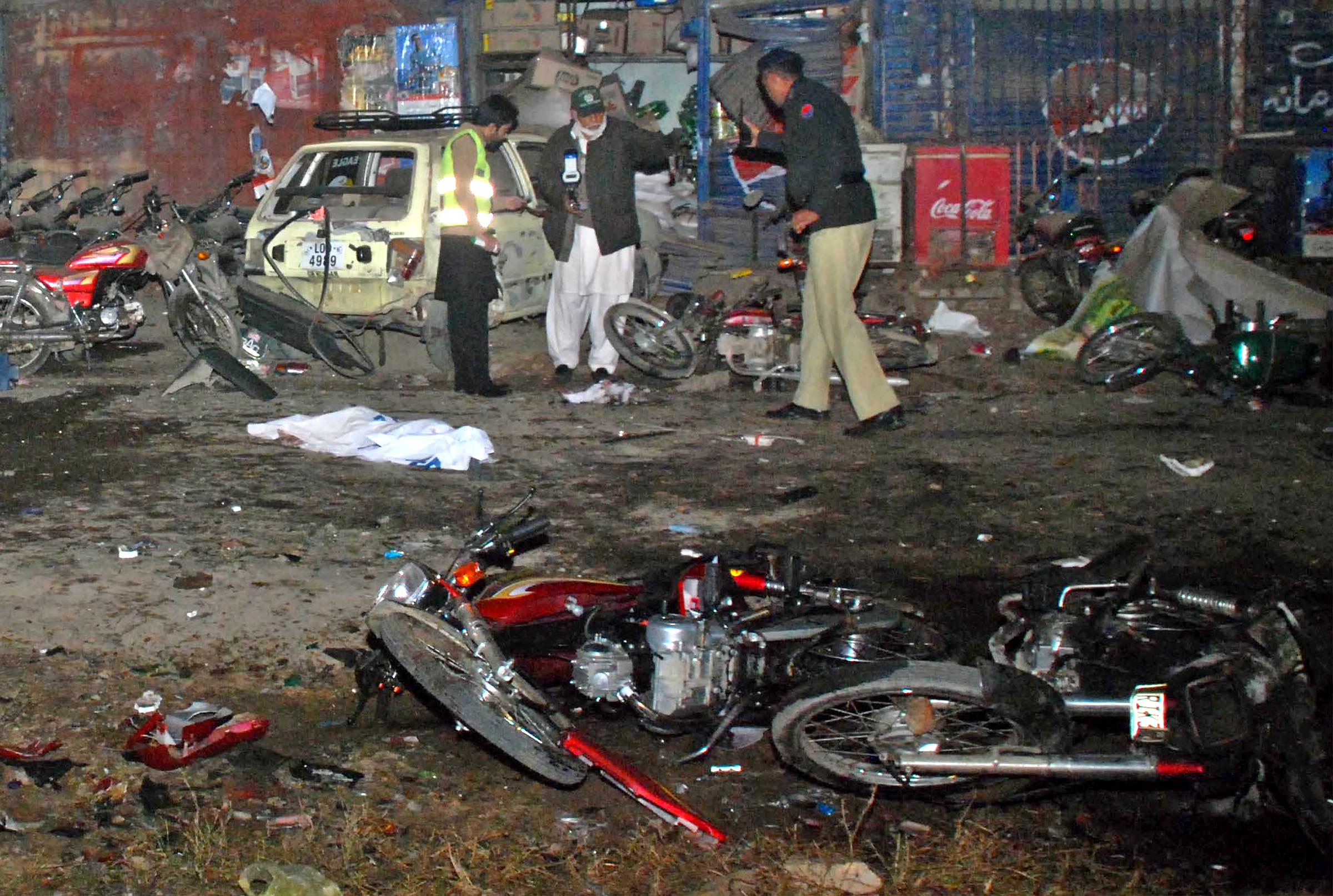police officials inspect the site of the blast in rawalpindi on tuesday photo mohammad javaid express