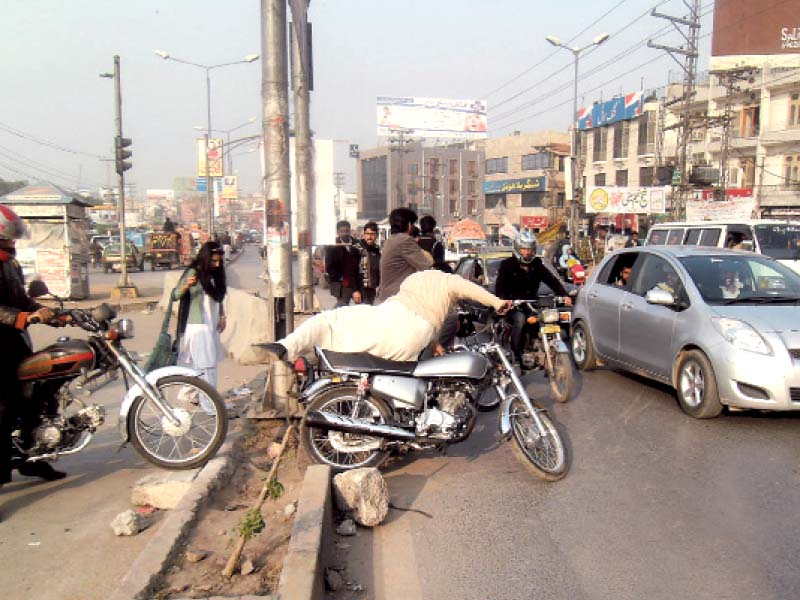 motorcyclists crossing over a divider putting the lives of pedestrians and drivers at risk photo express