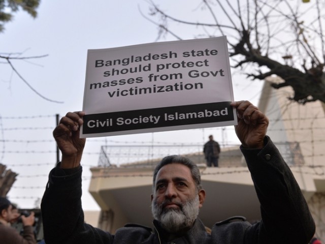 a pakistani civil society activist holds up a placard during a protest against the execution of bangladeshi islamist leader abdul quader molla outside the high commission of bangladesh in islamabad on december 17 2013 photo afp