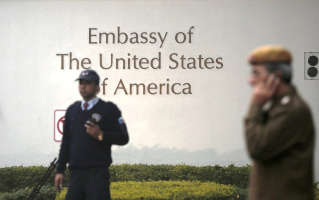 a u s embassy security guard l and an indian policeman stand in front of the main gate of the embassy as the bulldozer unseen removes the security barriers in new delhi december 17 2013 photo reuters a u s embassy security guard l and an indian policeman stand in front of the main gate of the embassy as the bulldozer unseen removes the security barriers in new delhi december 17 2013 photo reuters