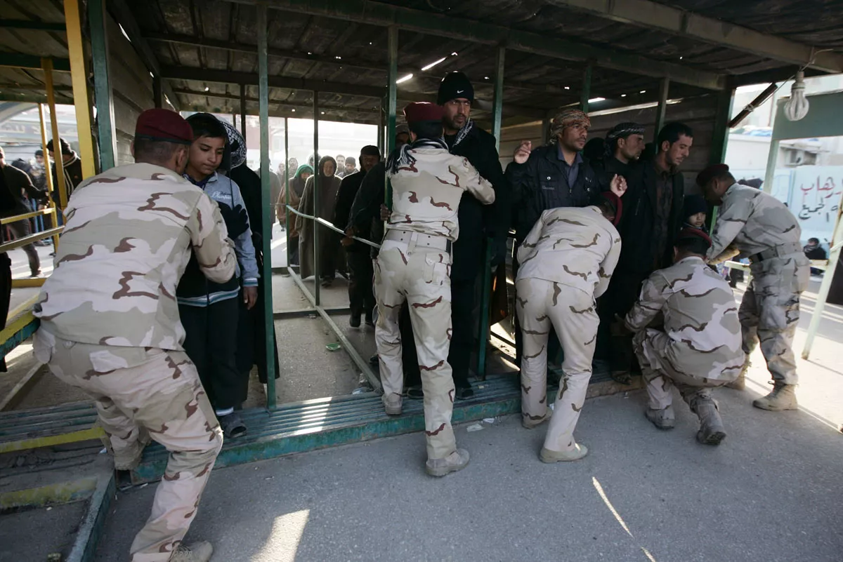 iraqi policemen search pilgrims at the outskirts of the city of kerbala about 80 km 50 miles southwest of baghdad december 18 2013 photo reuters iraqi policemen search pilgrims at the outskirts of the city of kerbala about 80 km 50 miles southwest of baghdad december 18 2013 photo reuters