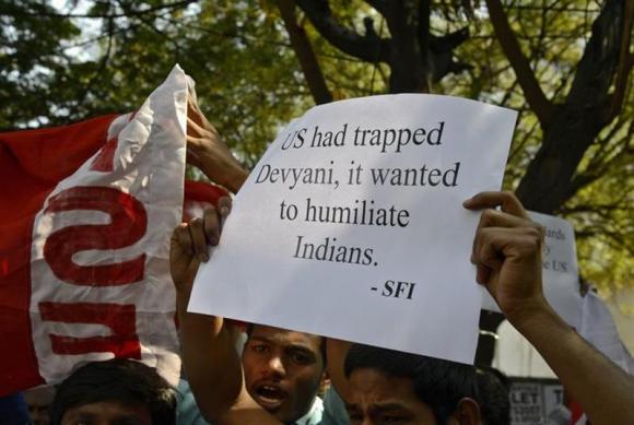 a member of the student federation of india sfi holds up a poster while shouting slogans during a protest outside the u s consulate office in the southern indian city of hyderabad december 19 2013 photo reuters