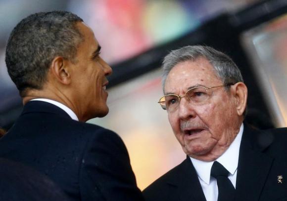 us president barack obama greets cuban president raul castro before giving his speech at the memorial service for late south african president nelson mandela photo reuters