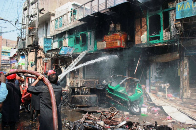 rescue workers trying to extinguish fire that erupted after the explosion in peshawar 039 s qissa khwani area on september 29 2013 photo muhammad iqbal rescue workers trying to extinguish fire that erupted after the explosion in peshawar 039 s qissa khwani area on september 29 2013 photo muhammad iqbal