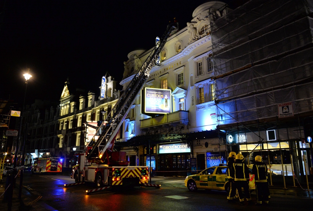 emergency services personnel use a hydraulic lift to investigate the cause of a ceiling collapse at a theatre in central london on december 19 2013 photo afp