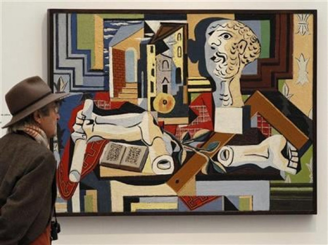 a man stands in front of a painting by pablo picasso photo reuters a man stands in front of a painting by pablo picasso photo reuters