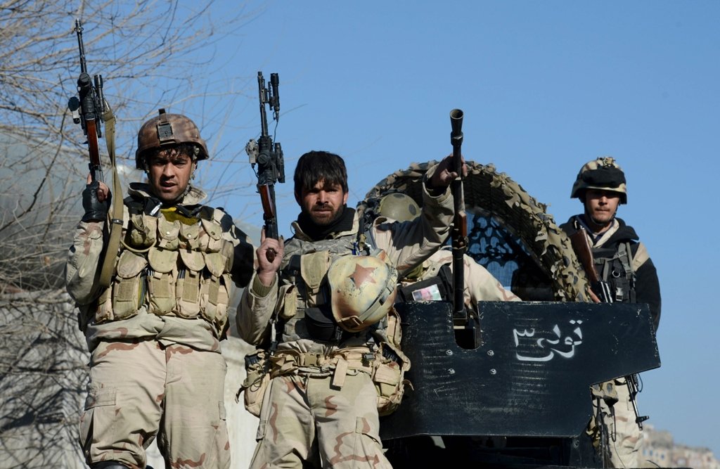 file photo of afghan commandos sitting on the top of their vehicle photo afp