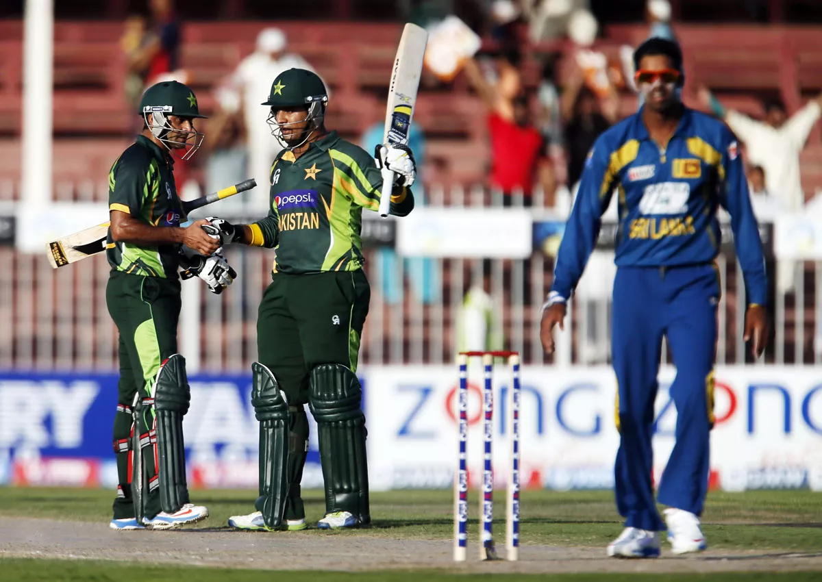 mohammad hafeez l and sharjeel khan c of pakistan salute each other photo afp mohammad hafeez l and sharjeel khan c of pakistan salute each other photo afp