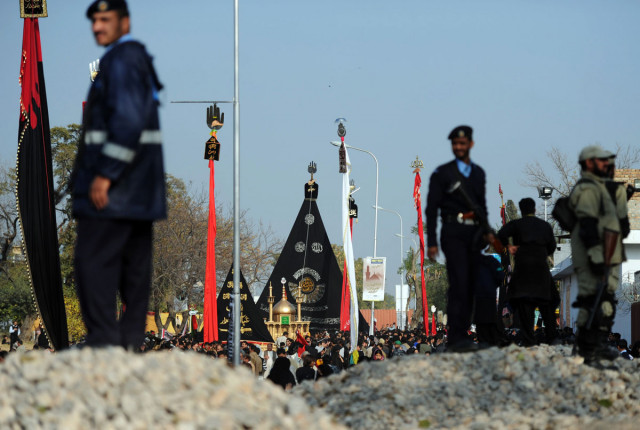 police and military personnel keep watch as mourners take part in a religious procession in islamabad on december 23 2013 photo afp police and military personnel keep watch as mourners take part in a religious procession in islamabad on december 23 2013 photo afp