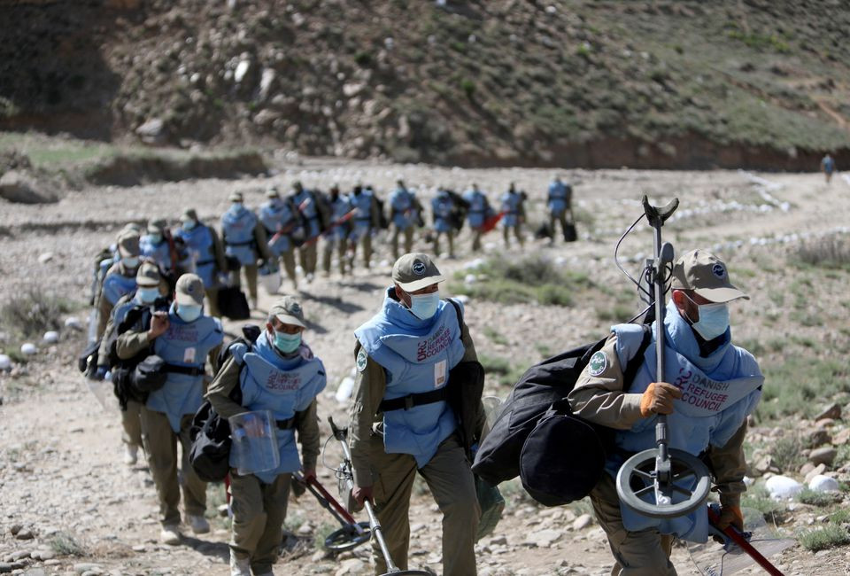 Members of a demining organisation are seen after their search for unexploded ordnance in Khaki Jabbar district of Kabul province, Afghanistan, April 4, 2022. REUTERS