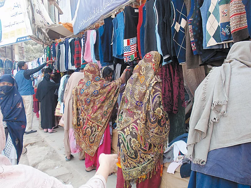 buyers skim through clothes at the lunda bazaar in sukkur to purchase warm winter wear at affordable prices photo express buyers skim through clothes at the lunda bazaar in sukkur to purchase warm winter wear at affordable prices photo express