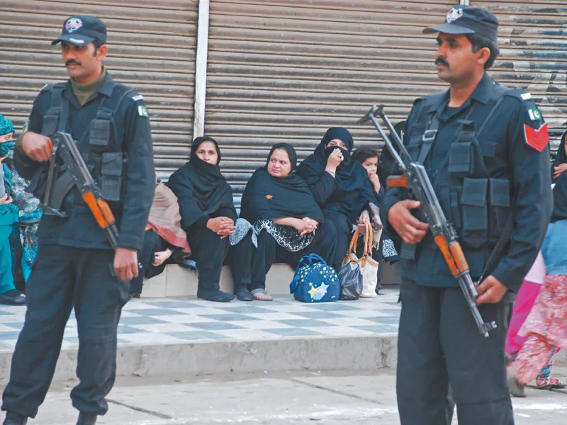 policemen stand guard as a chehlum procession passes through qissa khwani bazaar photo express policemen stand guard as a chehlum procession passes through qissa khwani bazaar photo express