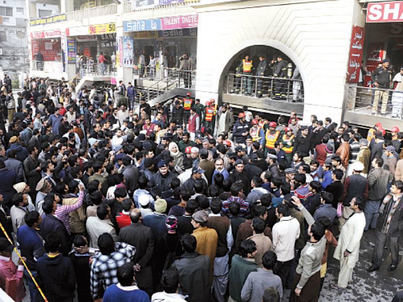 people gather outside ghakkar plaza after it caught fire photo agha mehroz express