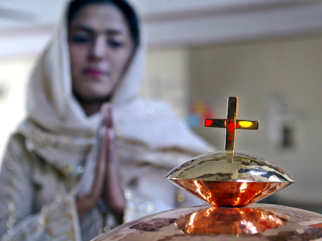 members of the christian community perform prayers during a ceremony to celebrate christmas at a church in peshawar photo epa