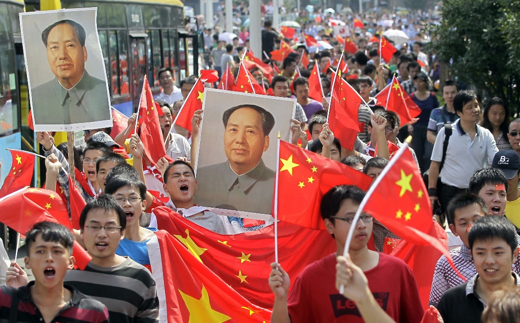 people holding posters of chairman mao photo reuters