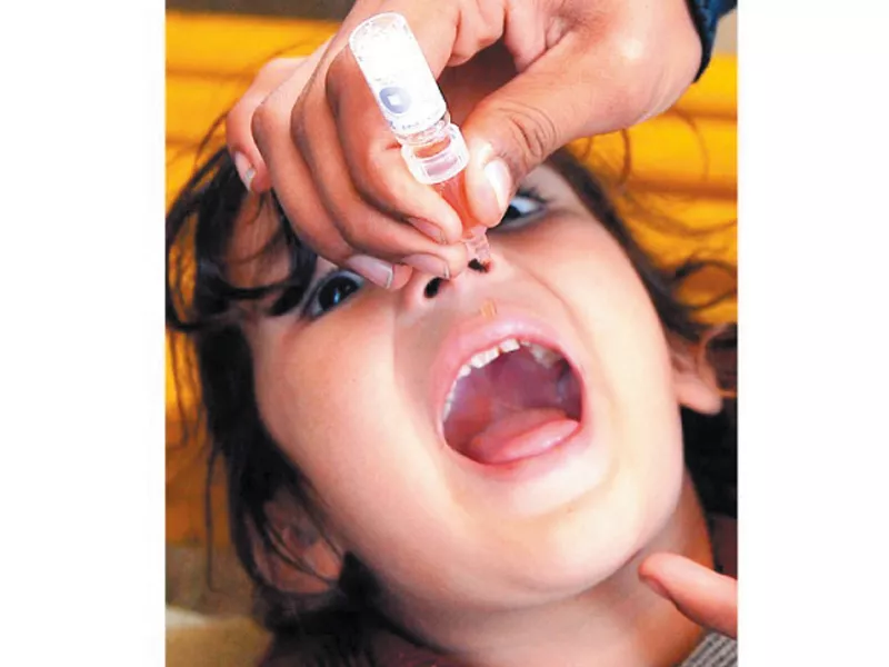 a pakistani polio vaccination worker administers vaccine drops to a young girl in peshawar photo afp a pakistani polio vaccination worker administers vaccine drops to a young girl in peshawar photo afp