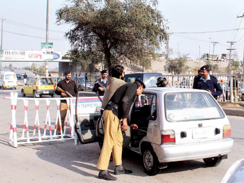 islamabad and rawalpindi police officials check a vehicle at faizabad photo app