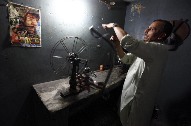 a worker checks a negative of an old pashto movie at arshad cinema in peshawar photo reuters a worker checks a negative of an old pashto movie at arshad cinema in peshawar photo reuters