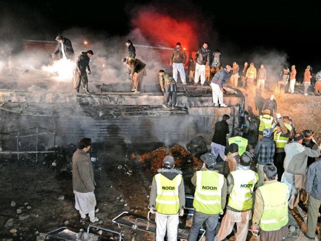 rescuers and security personnel gather around the burnt passenger bus at the site of the suicide car bomb attack photo afp rescuers and security personnel gather around the burnt passenger bus at the site of the suicide car bomb attack photo afp