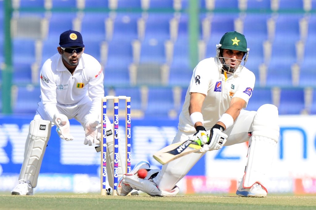 batsman misbah ul haq r plays a shot as sri lankan wicketkeeper prasanna jayawardene l looks on during the third day of the first cricket test match between pakistan and sri lanka at the sheikh zayed stadium in abu dhabi on january 2 2014 photo afp