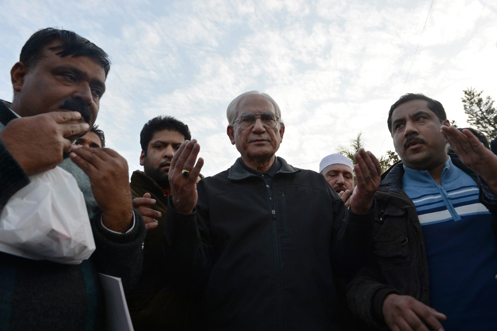 ahmed raza kasuri one of the lawyers of pakistan 039 s former military ruler pervez musharraf c joins supporters in prayer outside the armed forces institute of cardiology in rawalpindi on january 3 2014 where musharraf is being treated photo afp