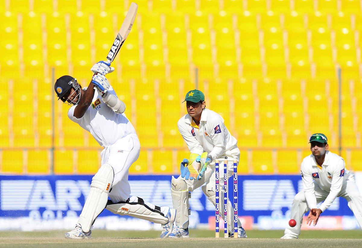 sri lankan batsman angelo mathews l plays a shot watched by pakistan wicketkeeper younis khan c during the final day of the first cricket test match between pakistan and sri lanka at the sheikh zayed stadium in abu dhabi on january 4 2014 photo afp