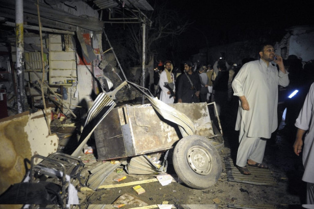 security officials examine the site of a suicide bomb attack photo afp security officials examine the site of a suicide bomb attack photo afp