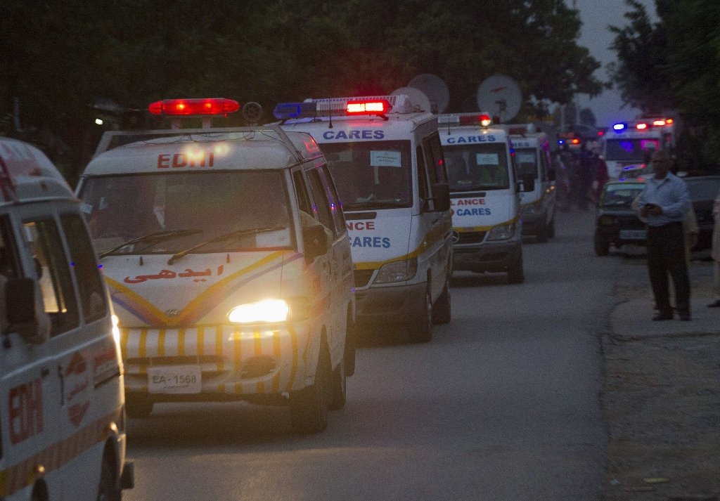 rescue workers and ambulances transporting the body of one of the victims of the nanga parbat tragedy photo reuters