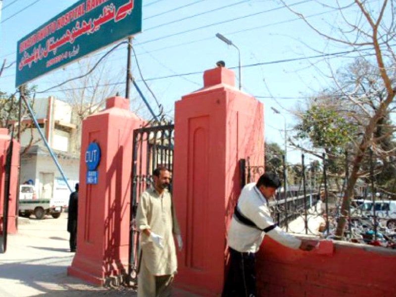 a man is plastering the outer wall of the benazir bhutto hospital photo file