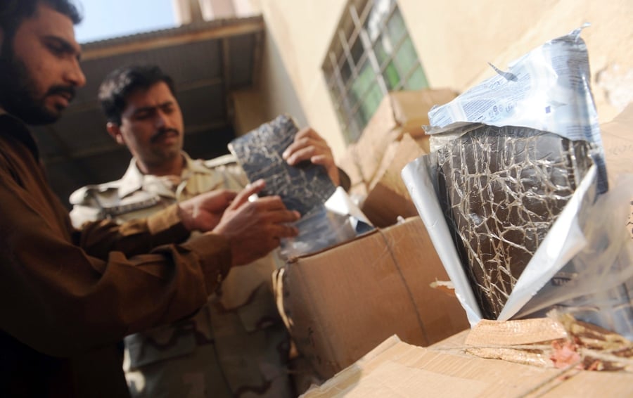 an old photo of anti narcotics officials organising hashish that was seized in a drug bust in karachi on november 15 2011 photo afp