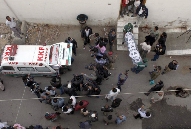 rescue officials remove bodies from an ambulance that had been recovered from a shrine in gulshan e maymar on tuesday photo mohammad azeem express