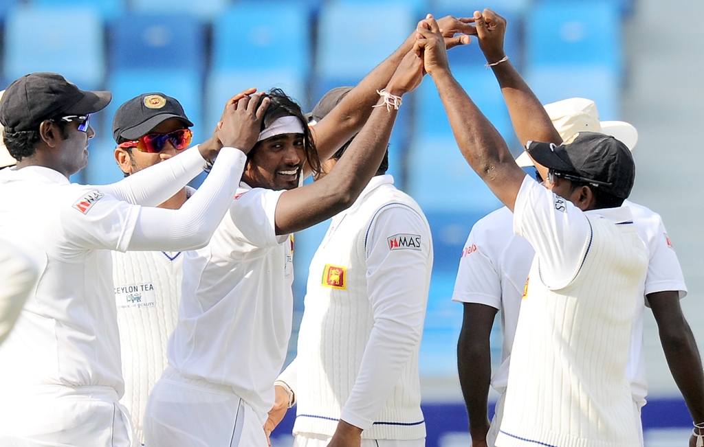 sri lankan bowler nuwan pradeep c celebrates with teammates after dismissing pakistan batsman sarfraz ahmed photo afp