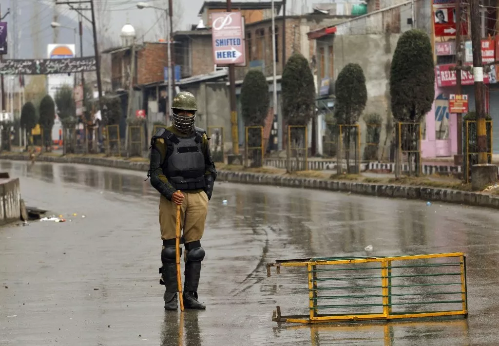 indian policeman wearing riot gear stands guard at a barricade setup in india photo reuters indian policeman wearing riot gear stands guard at a barricade setup in india photo reuters
