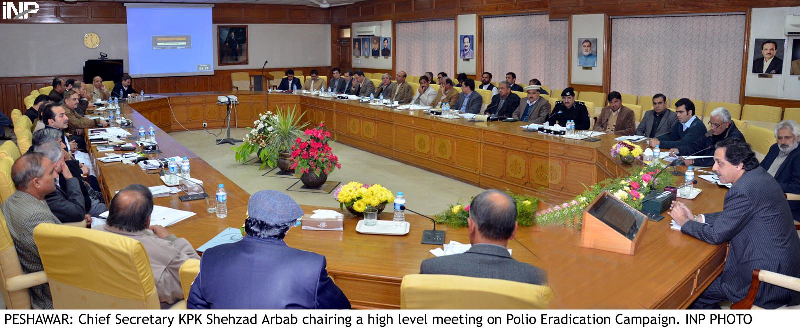 k p chief secretary shehzad arbab r chairing a meeting on polio eradication campaign photo inp