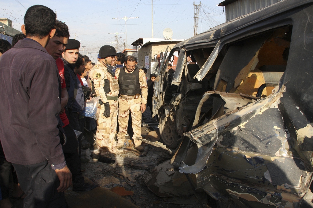 iraqi security forces inspect the site of car bomb attack in iraq photo reuters