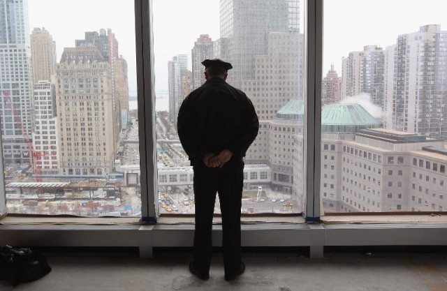 a police officer overlooking ground zero photo afp a police officer overlooking ground zero photo afp
