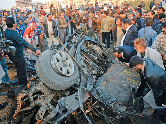 officials examine the wreckage of chaudhry aslam s vehicle photo afp officials examine the wreckage of chaudhry aslam s vehicle photo afp