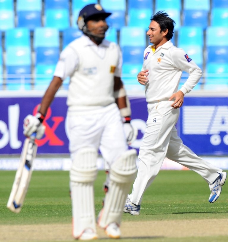 pakistan bowler saeed ajmal r celebrates after dismissing sri lankan batsman mahela jayawardene during the third day of the second cricket test match between pakistan and sri lanka at the dubai international cricket stadium in dubai on january 10 2014 photo afp