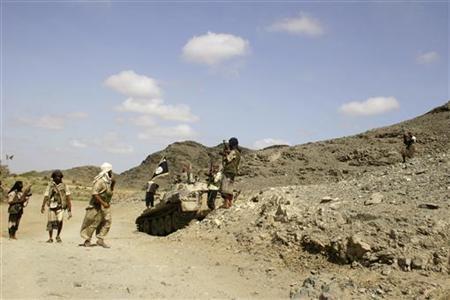 members of ansar al sharia an al qaeda affiliated group are seen near a tank taken from the army photo reuters