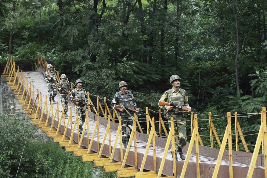 indian border security force bsf soldiers patrol over a footbridge built over a stream near the line of control loc a ceasefire line dividing kashmir between india and pakistan at sabjiyan sector of poonch district august 8 2013 photo reuters